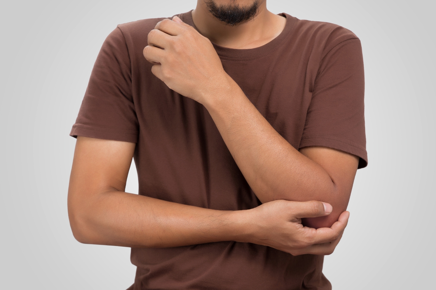 man med ont i armbåge